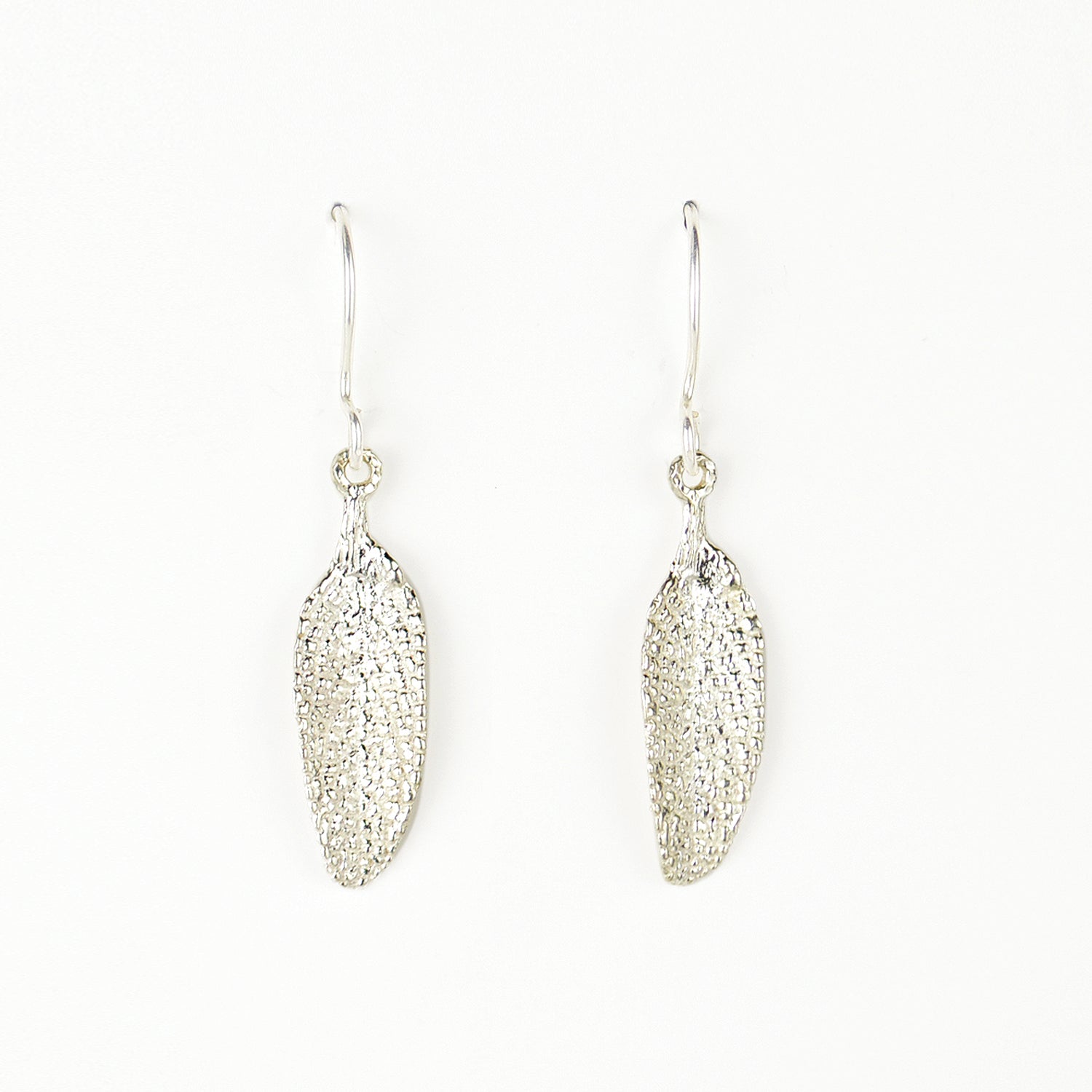 silver sage leaf earrings on plain white background. incredible detail