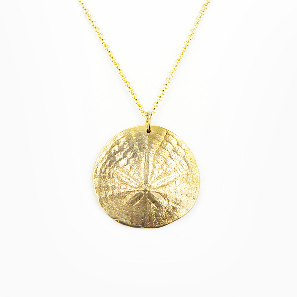 golden bronze sand dollar pendant necklace on white background