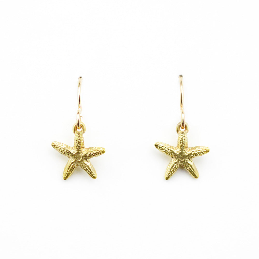 small golden bronze starfish earrings on a white background