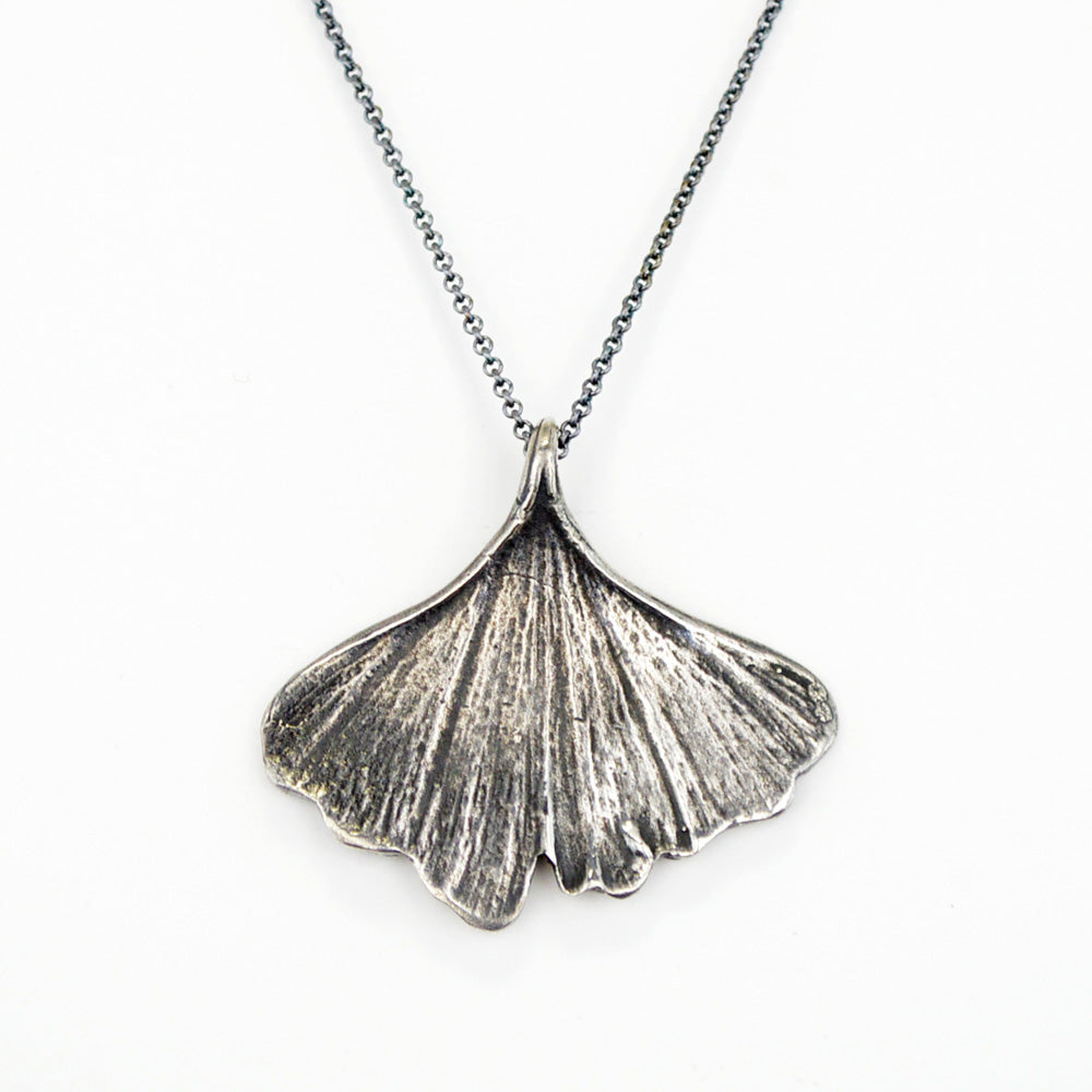 oxidized silver ginkgo leaf necklace on white background