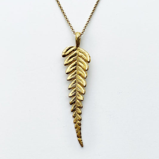 golden bronze fern leaf pendant necklace on white background