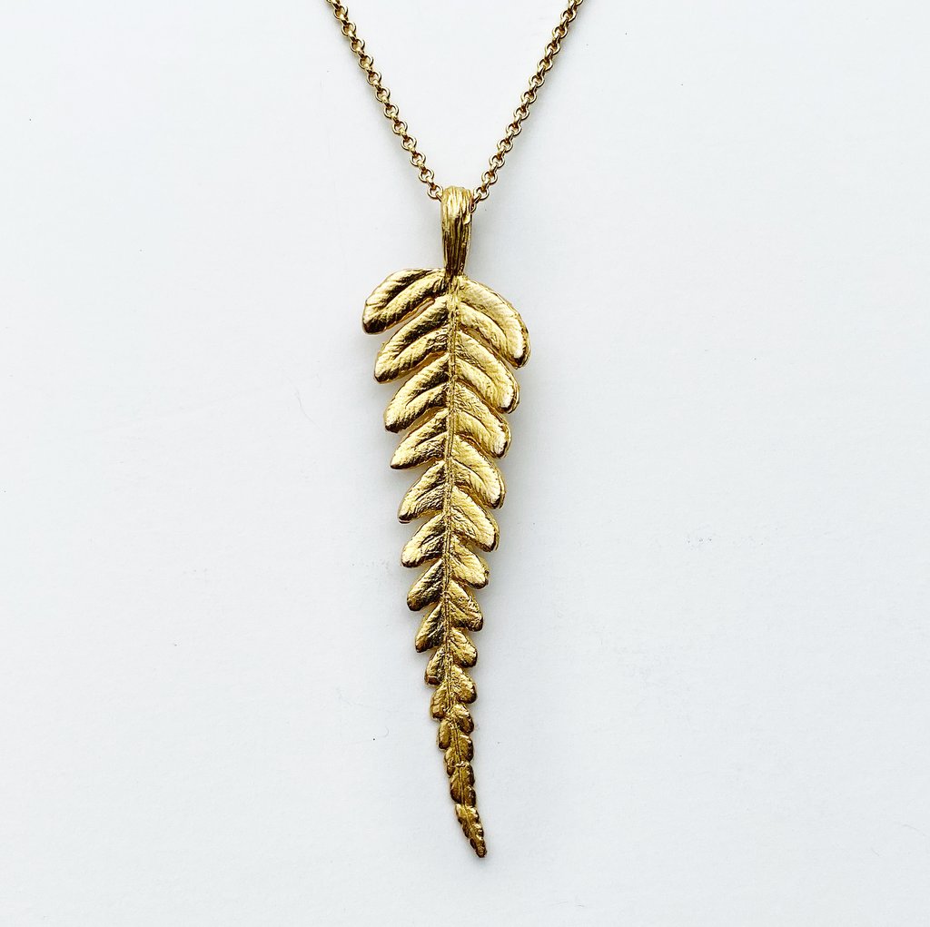 golden bronze fern leaf pendant necklace on white background