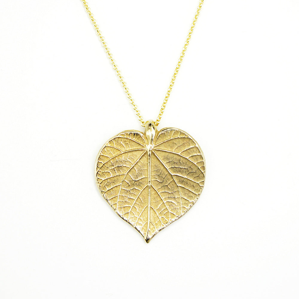 golden linden necklace pendant on white background