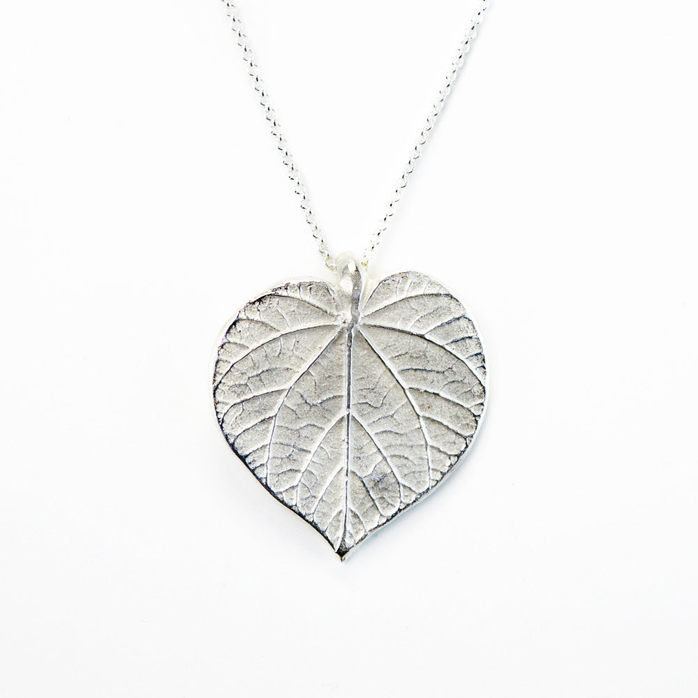 silver linden leaf necklace on white background