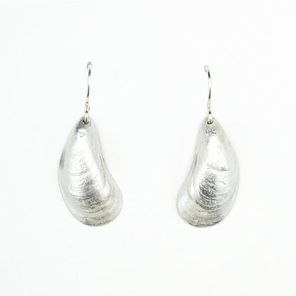 pair of sterling silver mussel shell earrings on white background