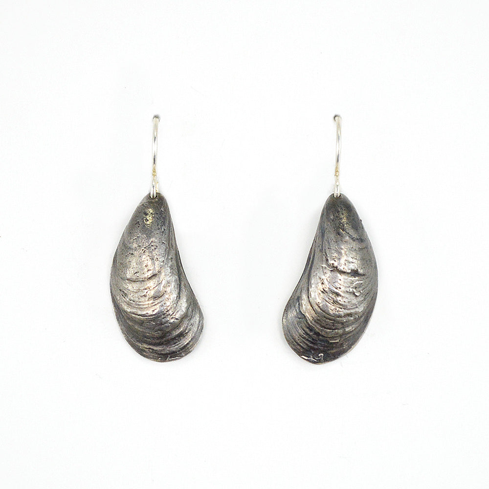 pair of oxidized silver mussel shell earrings on white background