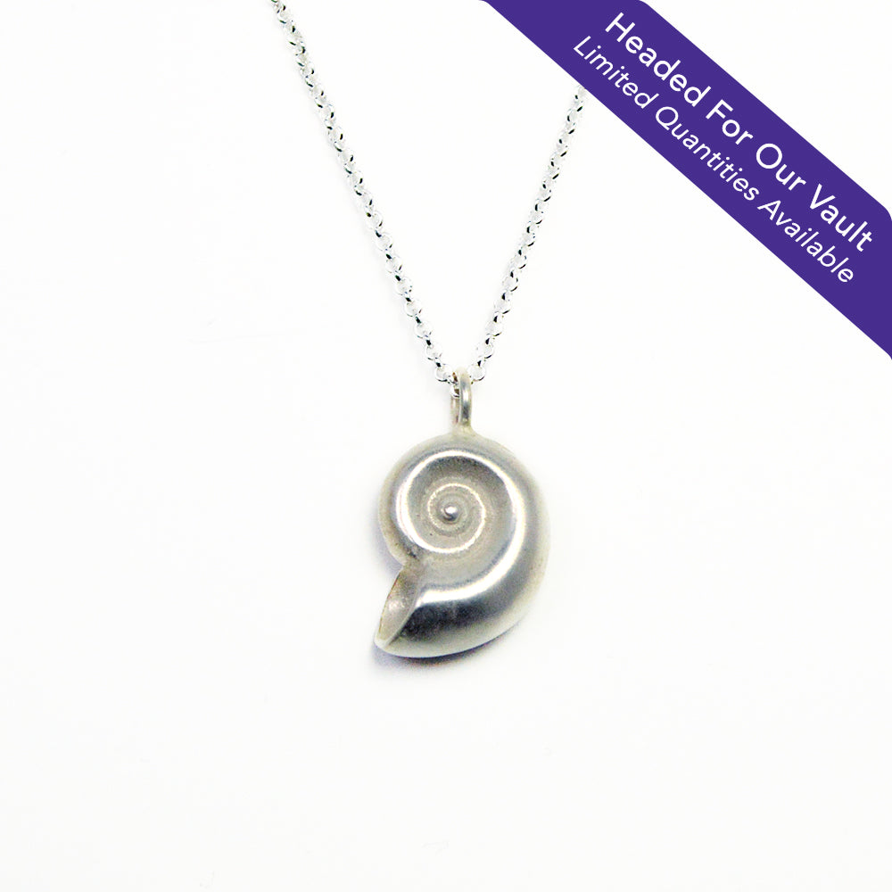 "Headed For Our Vault. Limited Quantities Available" sterling silver nautilus pendant necklace on a white background