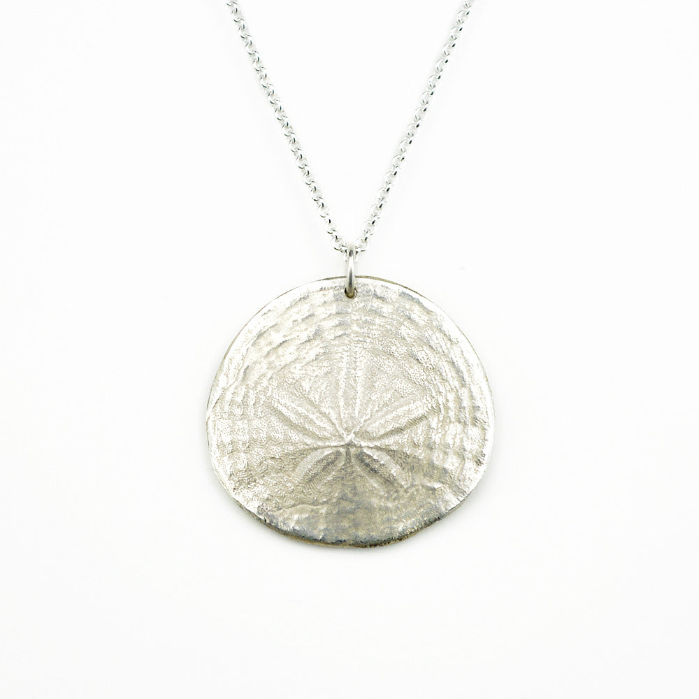 sterling silver sand dollar pendant necklace on white background