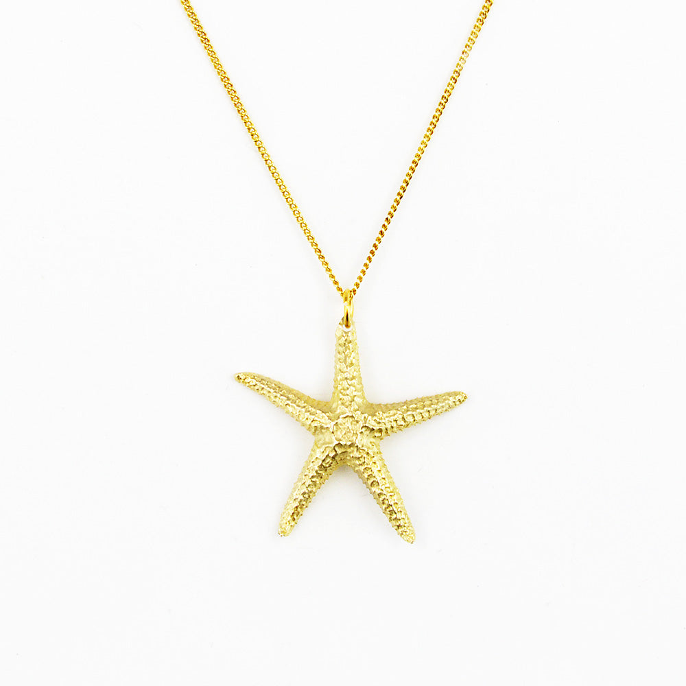 starfish pendant in golden bronze on white background