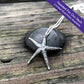 "Headed For Our Vault. Limited Quantities Available" starfish pendant in oxidized sterling silver on a weathered wooden background
