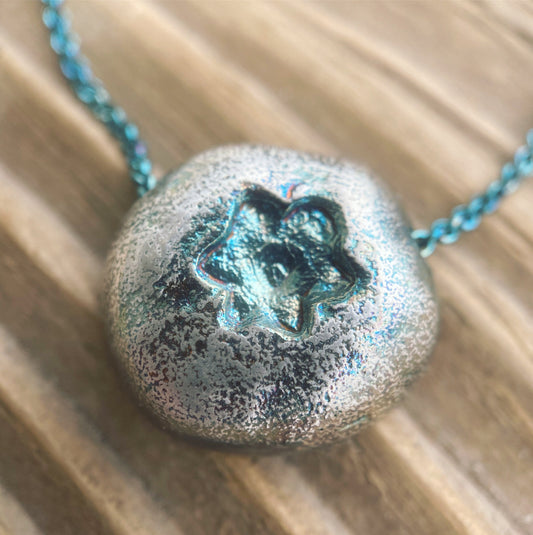 close up detailed image of a lifelike blueberry pendant necklace