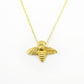gold bee necklace on white background