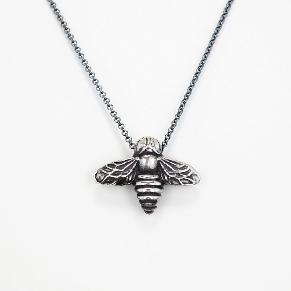 oxidized silver bee pendant on white background