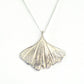 silver ginkgo leaf pendant necklace on white background