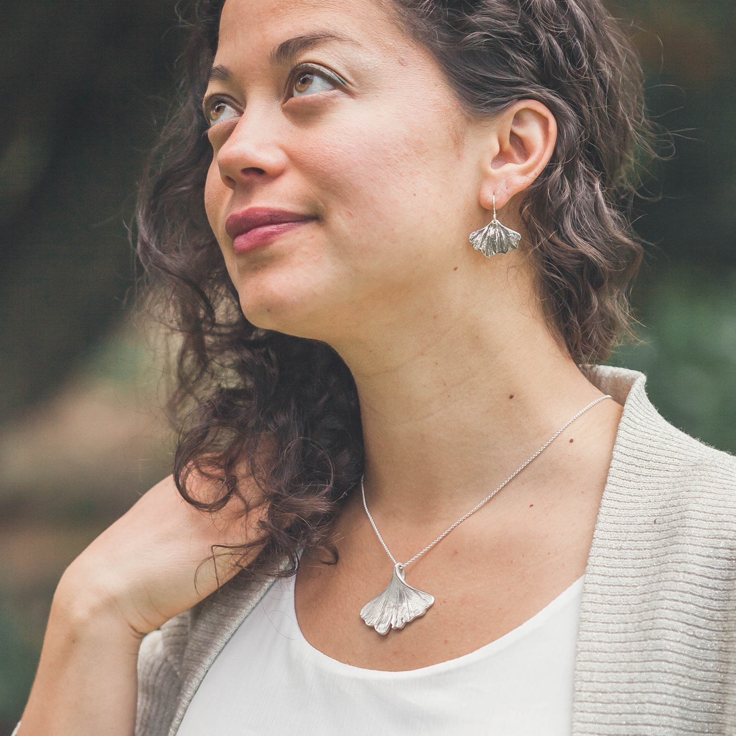 woman wearing ginkgo leaf necklace and ginkgo earrings