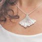 sterling silver ginkgo necklace worn with white shirt